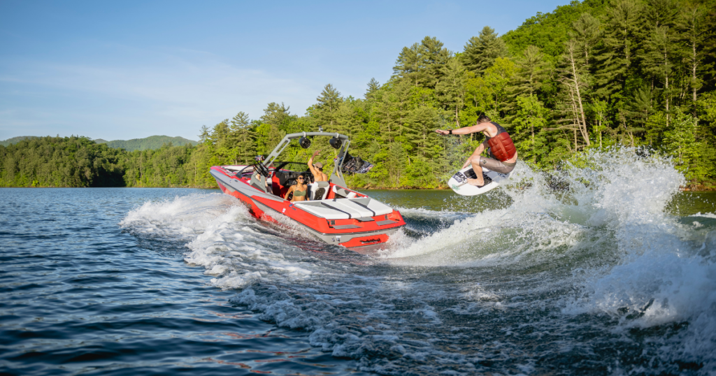 Boaters Having fun on a lake wakeboarding.